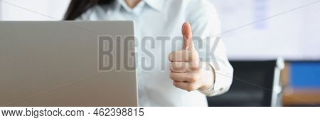 Close-up Of Office Clerk Showing Thumbs Up Gesture Working On Laptop. Smiling Employee Express Joy, 