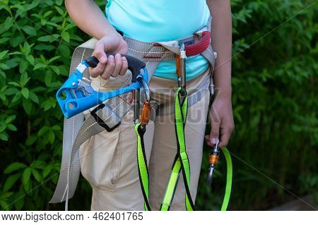 Belay Device For Climbing In Climbers Hands And Around His Waist