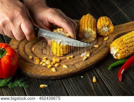 The Cook Cuts Corn With A Knife. Maize Is An Excellent Dietary Breakfast Or Lunch With Vegetables. W