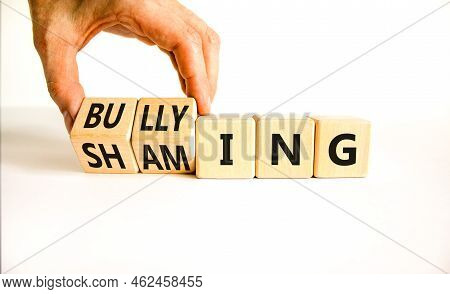 Shaming And Bullying Symbol. Concept Words Shaming And Bullying On Wooden Cubes. Businessman Hand. B