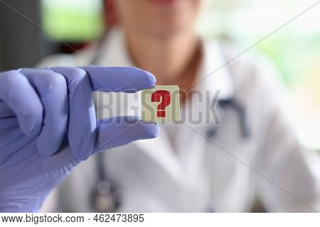 Question Mark In Hand Of General Practitioner Or Cardiologist In Clinic. Online Doctor Consultation 