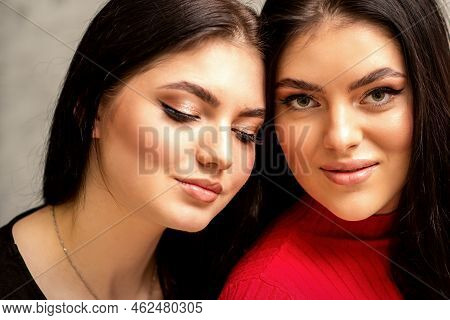Two Fashionable Young Women. Portrait Of The Two Beautiful Female Models With Long Hair And Makeup. 