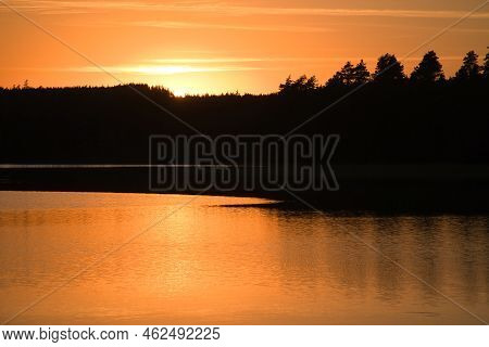 Sunset With Reflection On A Swedish Lake In Smalland. Romantic Evening Mood. Landscape Shot From Sca