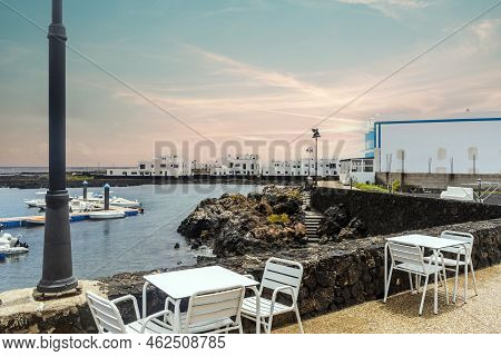 White Architecture On Black Volcanic Rocks In Corralejo, Lanzarote, Spain