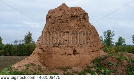 Close-up Background Of The Wall Of An Old House Made Of Clay Mixed With Straw. Old Type Of Construct