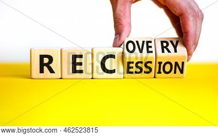 Recovery And Recession Symbol. Businessman Turns Cubes And Changes The Word 'recession' To 'recovery