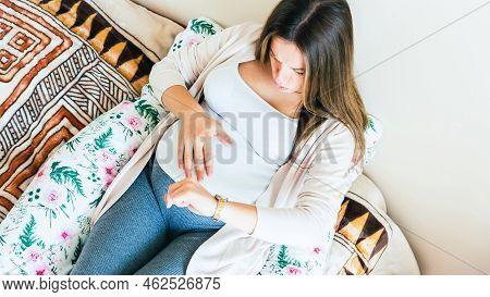 Pregnant Pain Contractions. Pregnant Woman Watching Clock, Holding Baby Belly. Childbirth Time, Cont