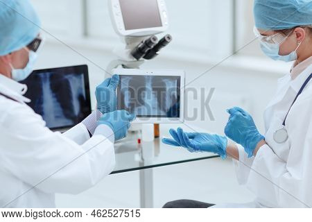 Close Up. Medical Colleagues Using A Digital Tablet In The Lab .