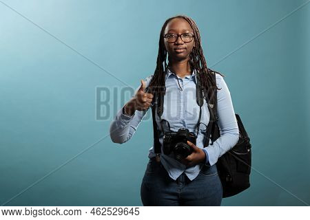 Joyful Photographer Giving Ok Finger Gesture While Standing On Blue Background. Cheerful Professiona