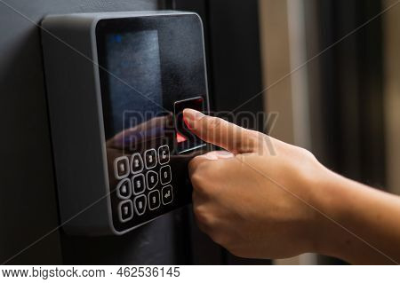 A Woman Opens The Door With Her Fingerprint. Modern Keyless Entry Lock.
