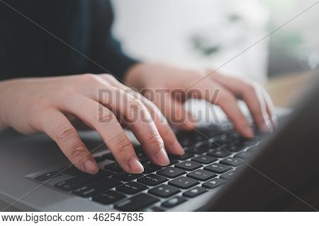 Business Concept. Woman Using Laptop To Work On Office Desk.