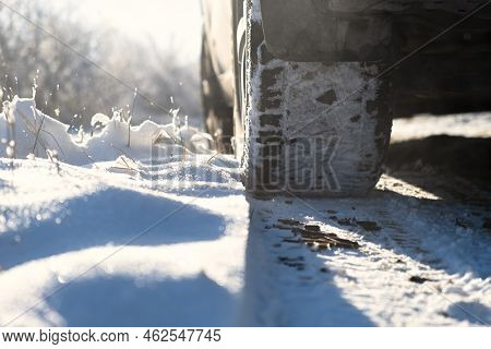 Car Wheels Snow Close-up. Driving On A Winter Road. Winter Tires Shooting From A Lower Angle. The Co