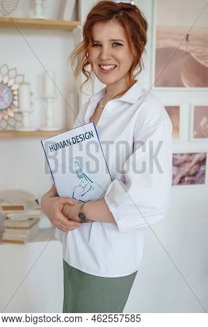 Tver, Russia-july 31, 2022 A Business Woman With A Book On Human Design In Her Hands. A Human Design
