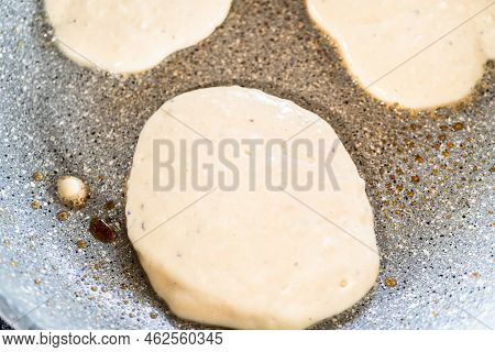 Frying Kefir Based Pancakes In Cooking Pan On An Electric Stove.