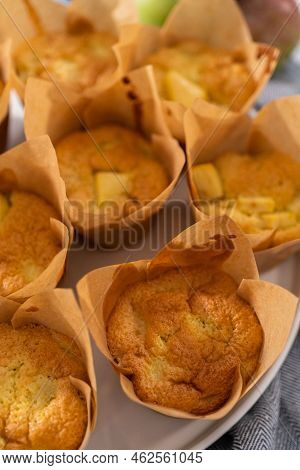 Garnishing Freshly Baked Apple Sharlotka Muffins Dusted With Powdered Sugar.