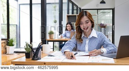 Asian Woman Working On A Laptop Computer, Working In The Office With Laptop Concept, Young Asian Wom