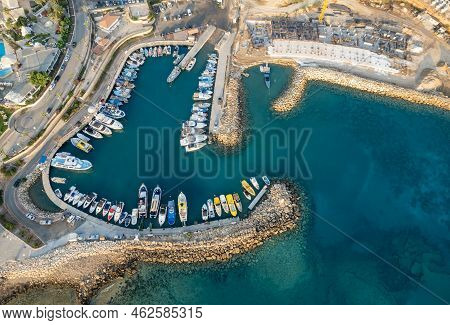Drone Aerial Scenery Of A Fishing Port At Pernera Protaras Cyprus. Fishing Boats Moored In The Harbo
