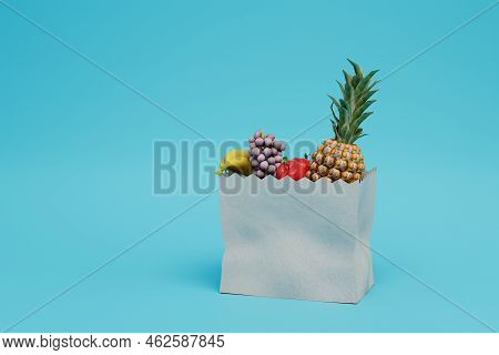 The Concept Of Proper Nutrition. Buying Fruit In The Store. Fruit Bag On A Blue Background. Copy Pas