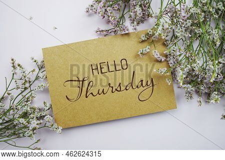 Hello Thursday Written On Paper Card With Flower Frame Decoraton On Pink Background