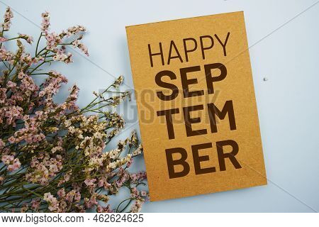 Happy September Written On Paper Card With Flower Frame Decoraton On Pink Background