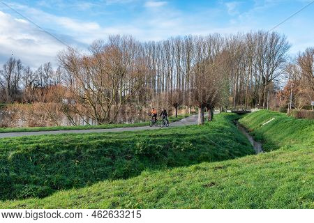 Anderlecht, Brussels Capital Region - Belgium - 12 25 2020  Two Middle Aged Man Driving The Bicycle 