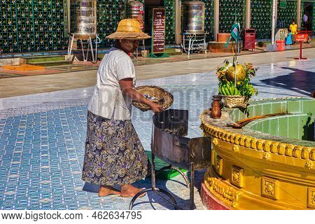 Yangon, Myanmar - December 03 2012 : A Woman In Traditional Dress, With Bamboo Hat And Clay Mask Pre