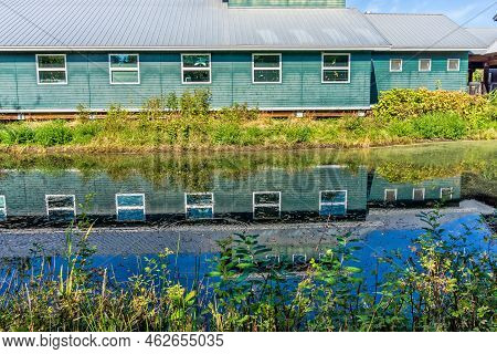 A Building In Reflecting In A Pond At The Nisqualy National Wildlife Refuge
