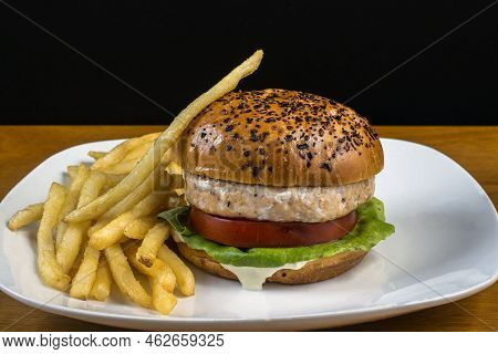 Salmon Buger On A Everthing Bagel  And Served With Fries