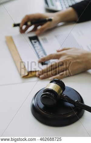Male Lawyer Working With Contract Papers And Wooden Gavel On Tabel In Courtroom. Justice And Law ,at
