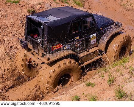 Russia - August 12, 2023, Tver. The Car Overcomes Difficult Obstacles. Large-scale Sports Competitio
