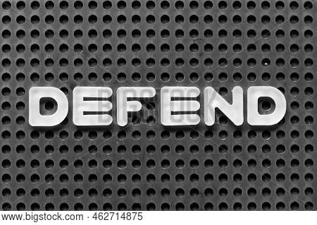 White Alphabet Letter In Word Defend On Black Pegboard Background