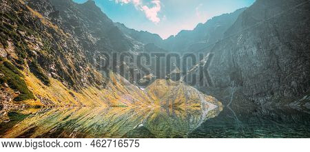 Tatra National Park, Poland. Calm Lake Czarny Staw Under Rysy And Summer Mountains Landscape. Sunshi