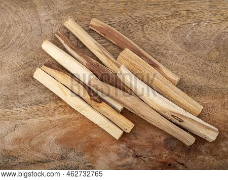 Palo Santo Burning In Front Of Wood Background