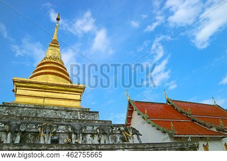 The Upper Part Of Wat Phra That Chang Kham Worawihan Temple's Main Chedi And Ordination Hall, Nan Pr