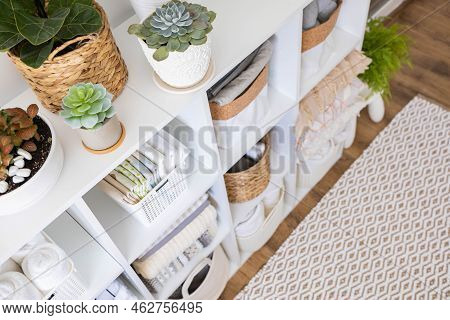 Neatly Folded Linen Cupboard Shelves Storage At Eco Friendly Straw Basket Placed Closet Organizer