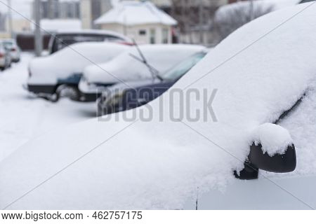Car Parked On Street Under Winter Snow Fall