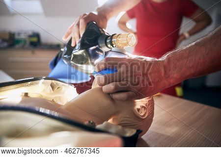 Paramedic Of Emergency Medical Service Training Resuscitation Procedure On Child Dummy.