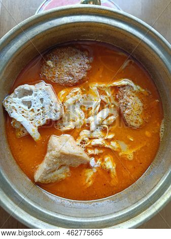 Top View Of Singapore Chicken Laksa Served With Noodles And Tofu On A Hot Bowl