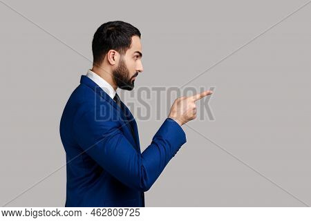 Side View Portrait Of Serious Strict Bearded Man Standing With Admonishing Gesture, Scolding For Mis