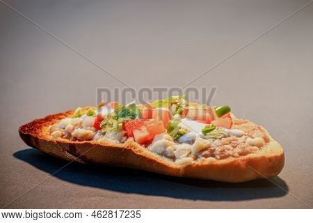 Mexican Molletes, Traditional Food With Bread, Beans, Cheese, Tomato And Chili