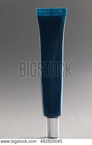 Blue Tube With Cream On A Gray Background, Close-up. Facial Cosmetics, Non-comedogenic, Skincare And