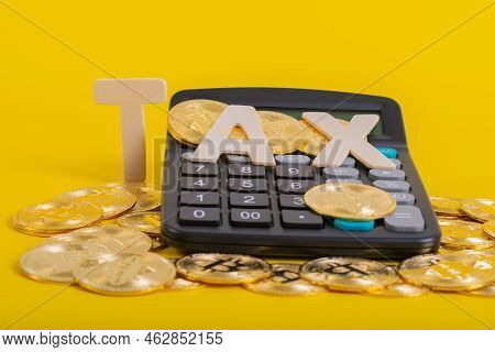 Tax Btc Cryptocurrency With Tax Wording On Bitcoin And Caculator On Stock Graph Yellow Background