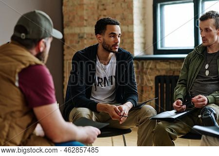 Young Unhappy Man Sharing His Problems With Other Attandants Of Session