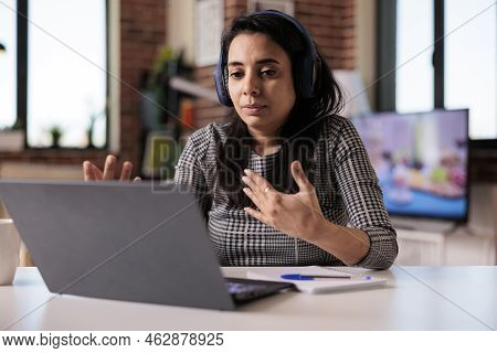 Indian Person Attending Videocall Conference On Laptop, Talking To People At Online Business Meeting