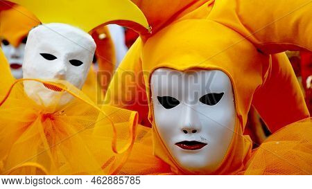Two Women Wear White Full Face Mask And Orange Headware On Head To Celebrate And Ready For Dance