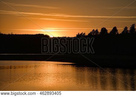 Sunset With Reflection On A Swedish Lake In Smalland. Romantic Evening Mood. Landscape Shot From Sca