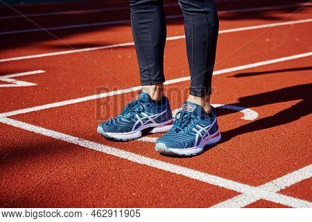 Male Sprinter Wearing Asics Gel Nimbus At Running Track. Sport And Fitness Runner Athlete Training A