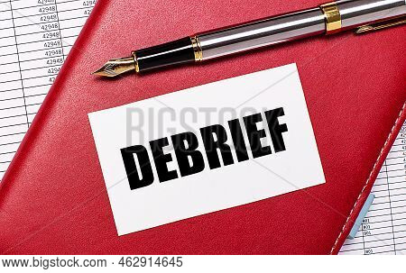 On The Desktop There Are Reports, A Burgundy Notebook, A Fountain Pen And A White Blank Card With Th