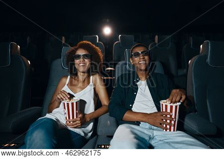 Couple Watching Movie With Popcorn In Cinema. High Quality Photo