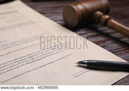 Last Will And Testament With Pen Near Gavel On Wooden Table, Closeup
